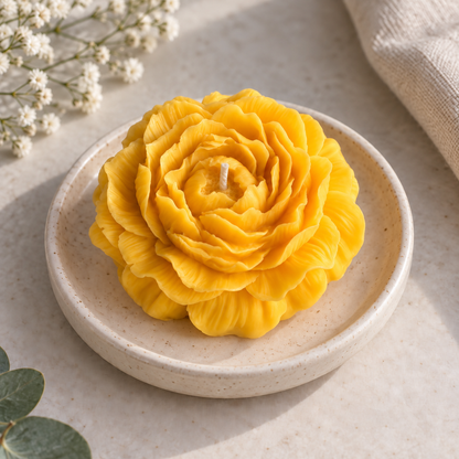 Yellow Peony Flower Soy Wax Candle with visible wick on a speckled ceramic dish